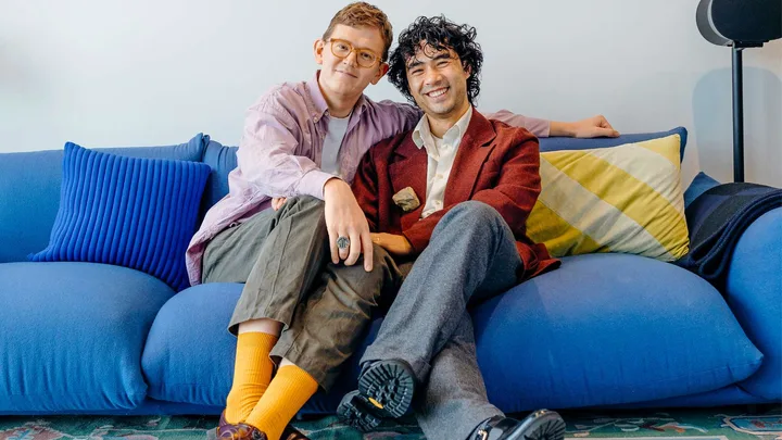 Chris and Micheal sitting on a blue couch together