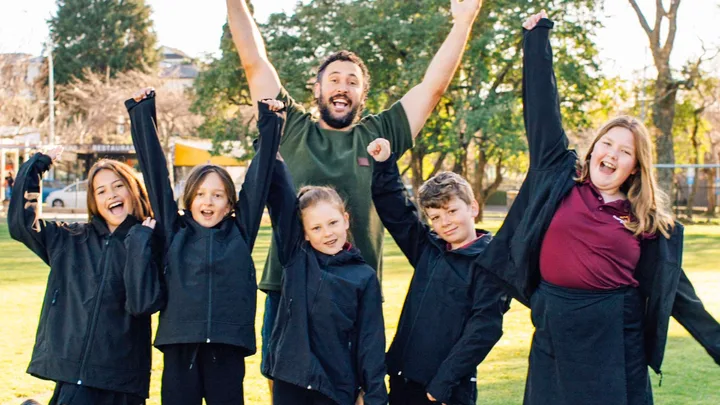 Jordan Watson with some school kids
