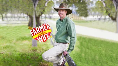 Farmer Wants a Wife star Andrew leaning on a fence