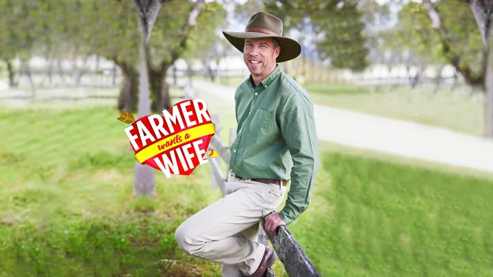 Farmer Wants a Wife star Andrew leaning on a fence