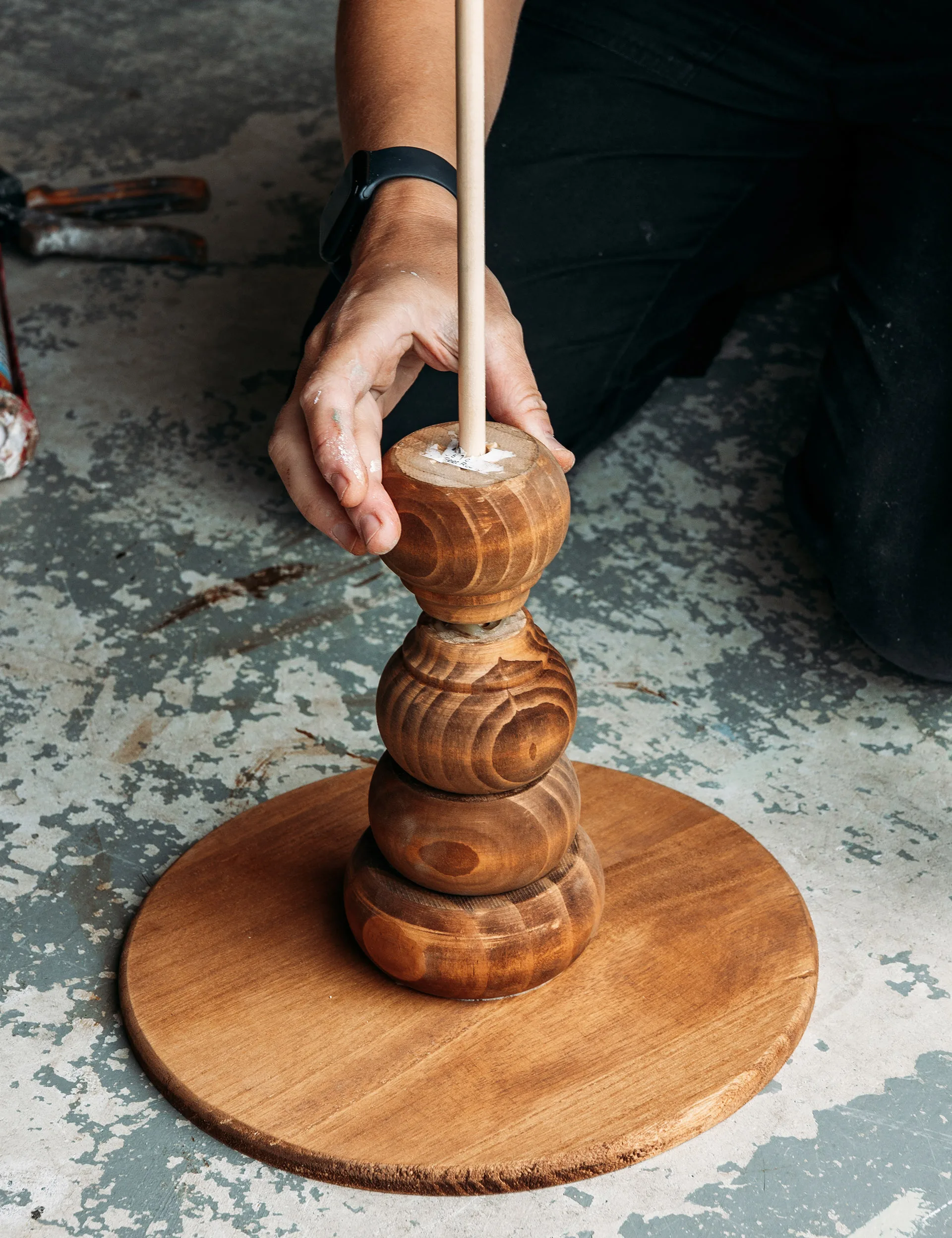 Start adding feet, sliding each one over the dowel rod and putting a small amount of glue in between each