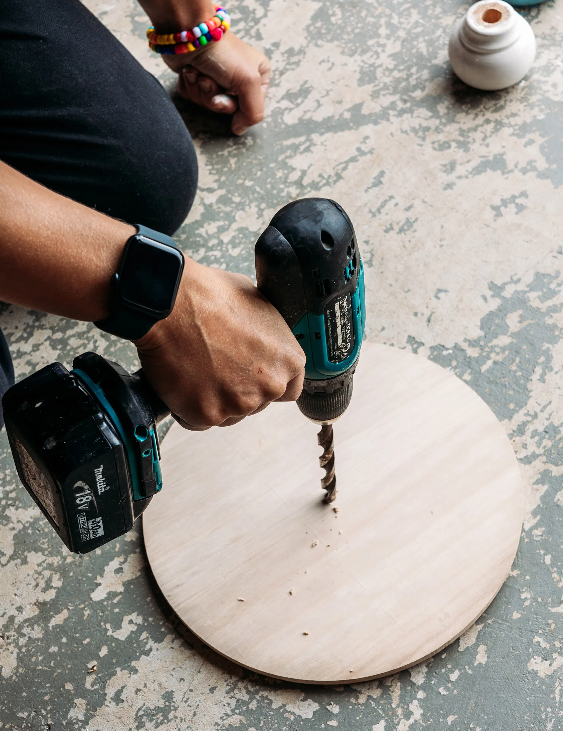 Using a 12mm drill bit, drill the hole in the centre of round timber