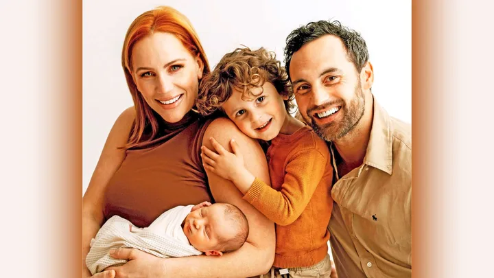 Jules and Cam with their son and new baby