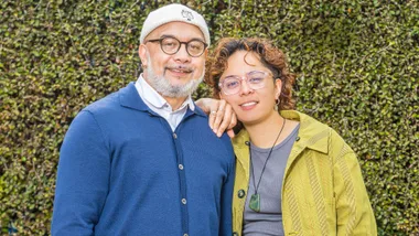 Ngā Rorirori creators Hone and Maarire in front of a hedge