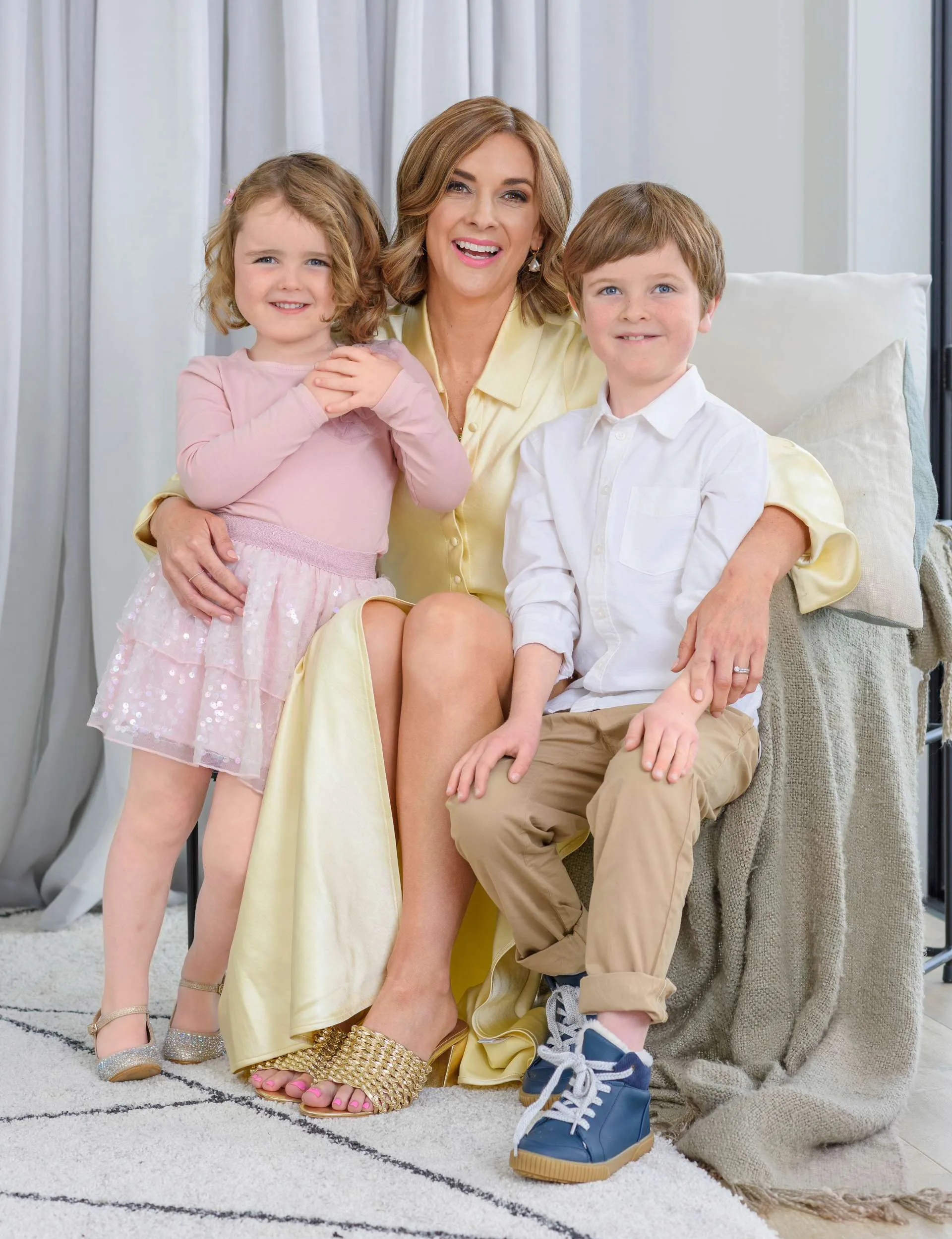 Susie Nordqvist with her kids on an arm chair