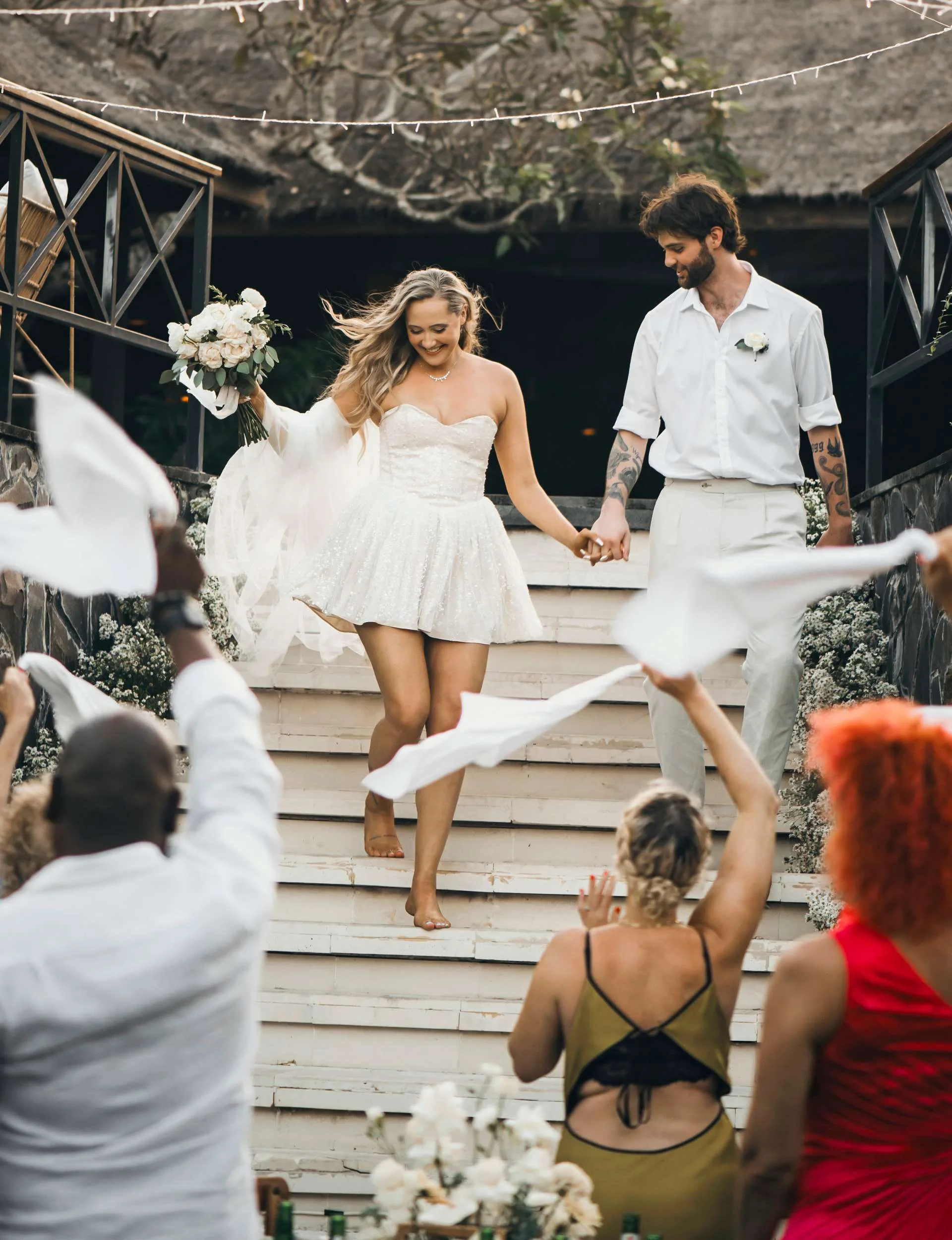 Brayden Inger and Georgina Fisher walking down a staircase into their wedding reception