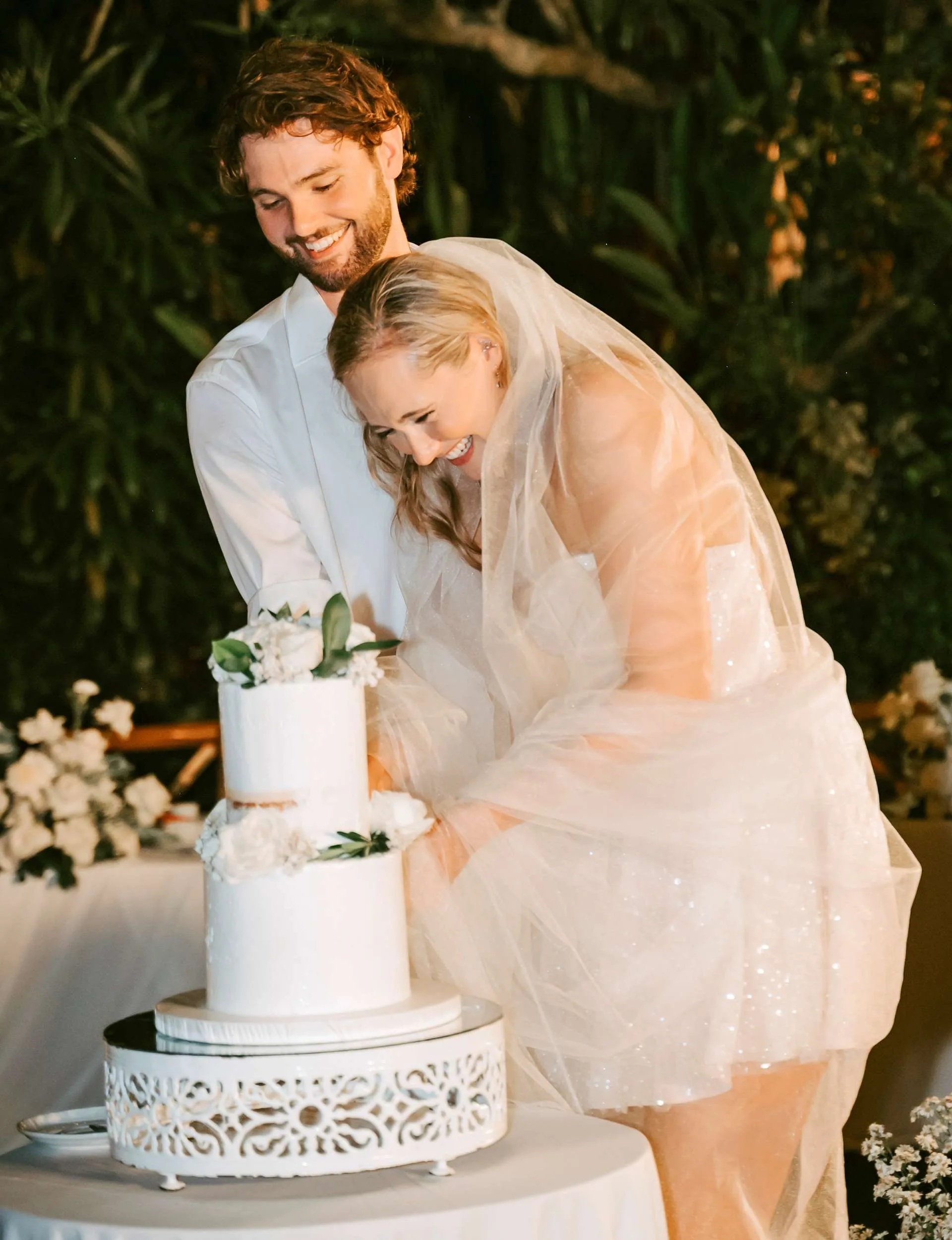 The couple cutting the cake