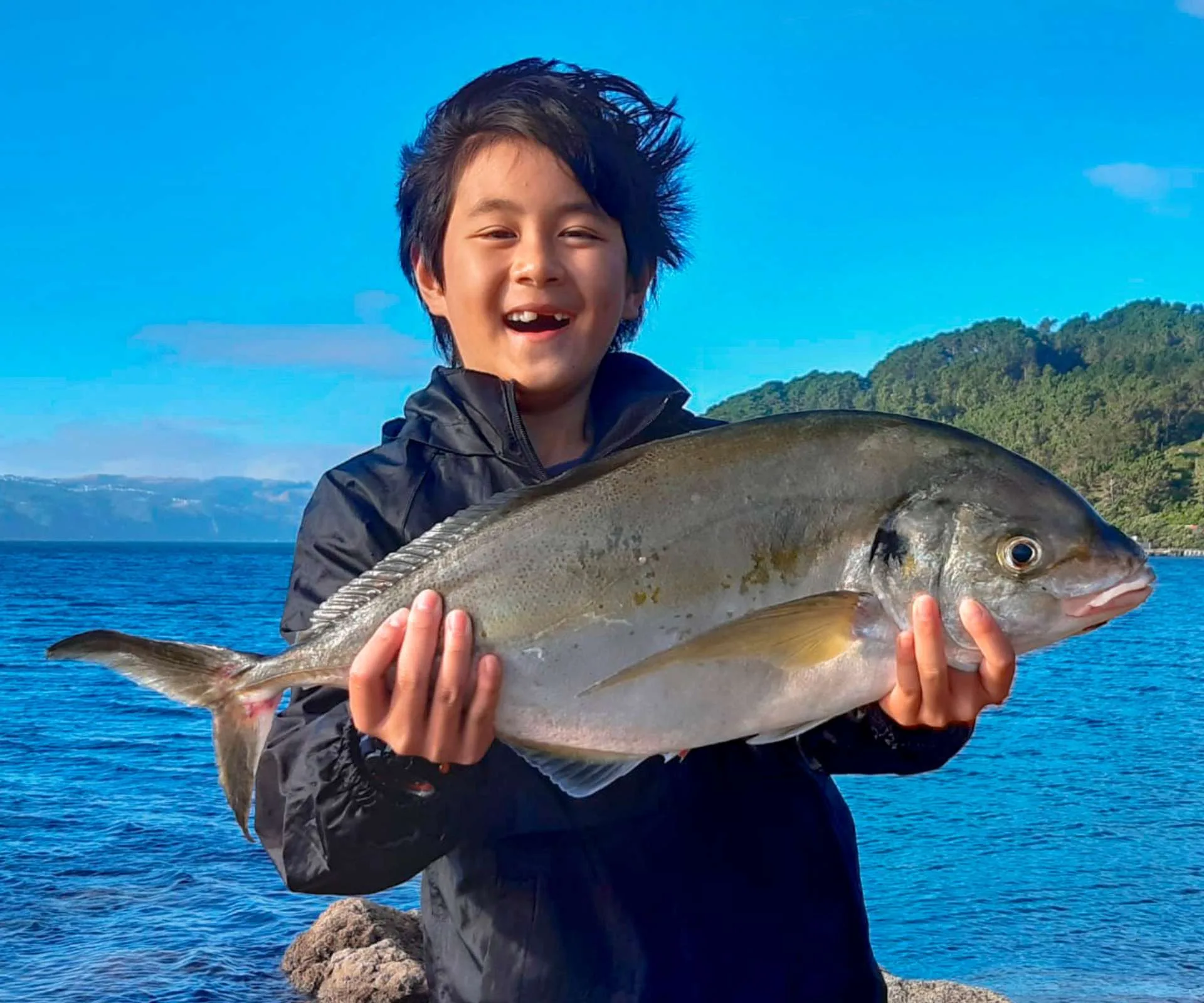 Boshu holding up a fish he caught on a trip with his Big Buddy
