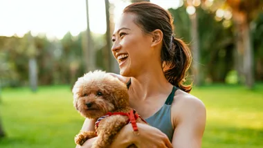 A woman holding a puppy with well-balanced hormones