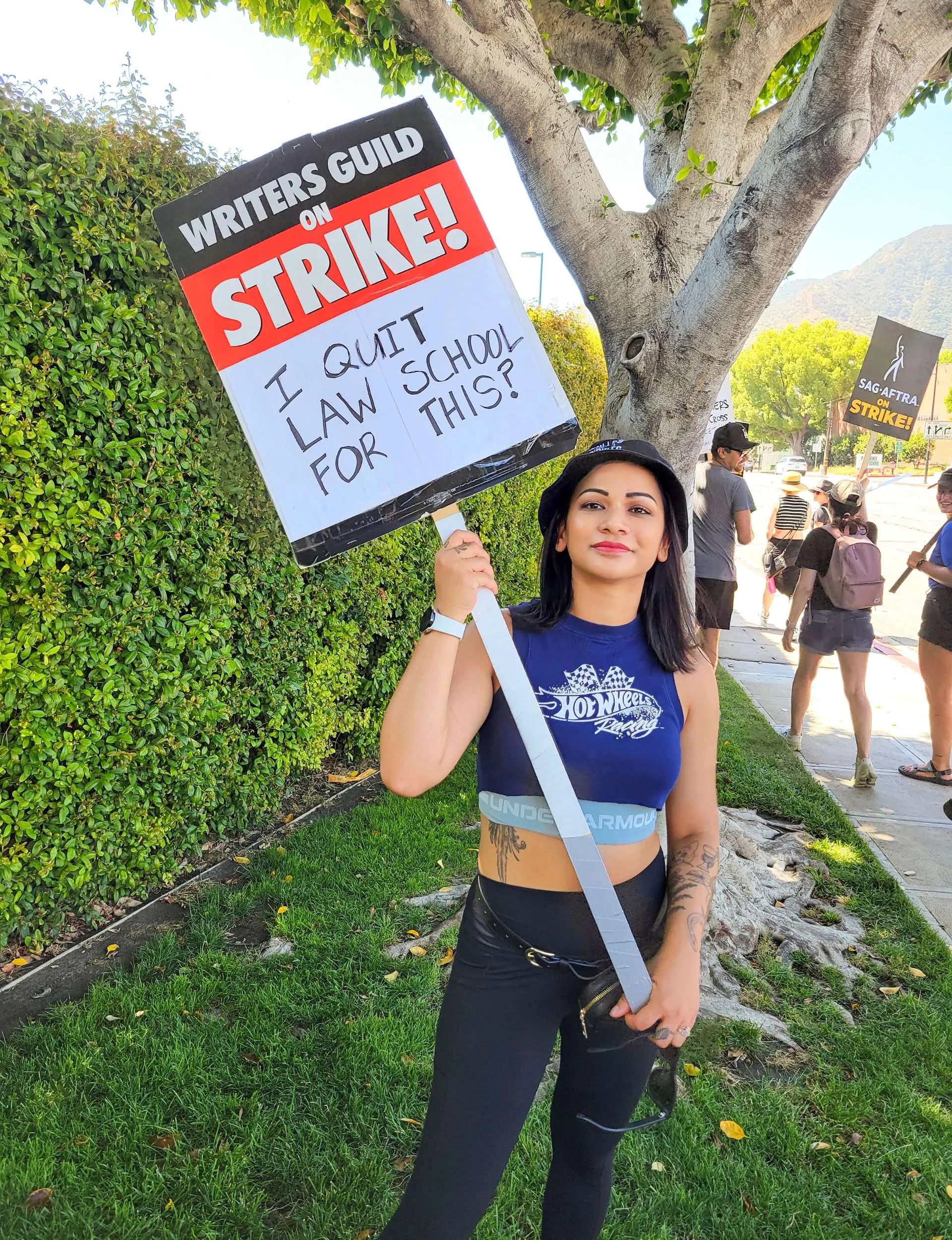 Shoshana Sachi holding up a sign at the writers' strike