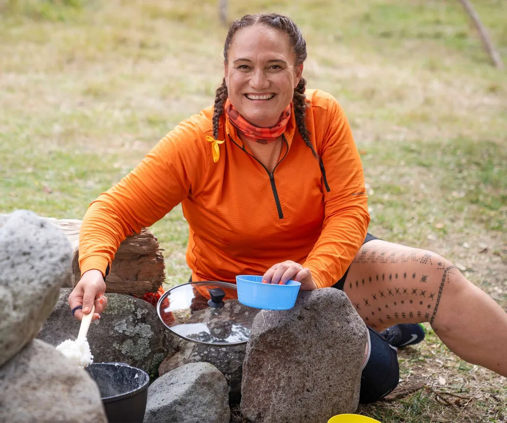 Carmel serving some food on Celebrity Treasure Island