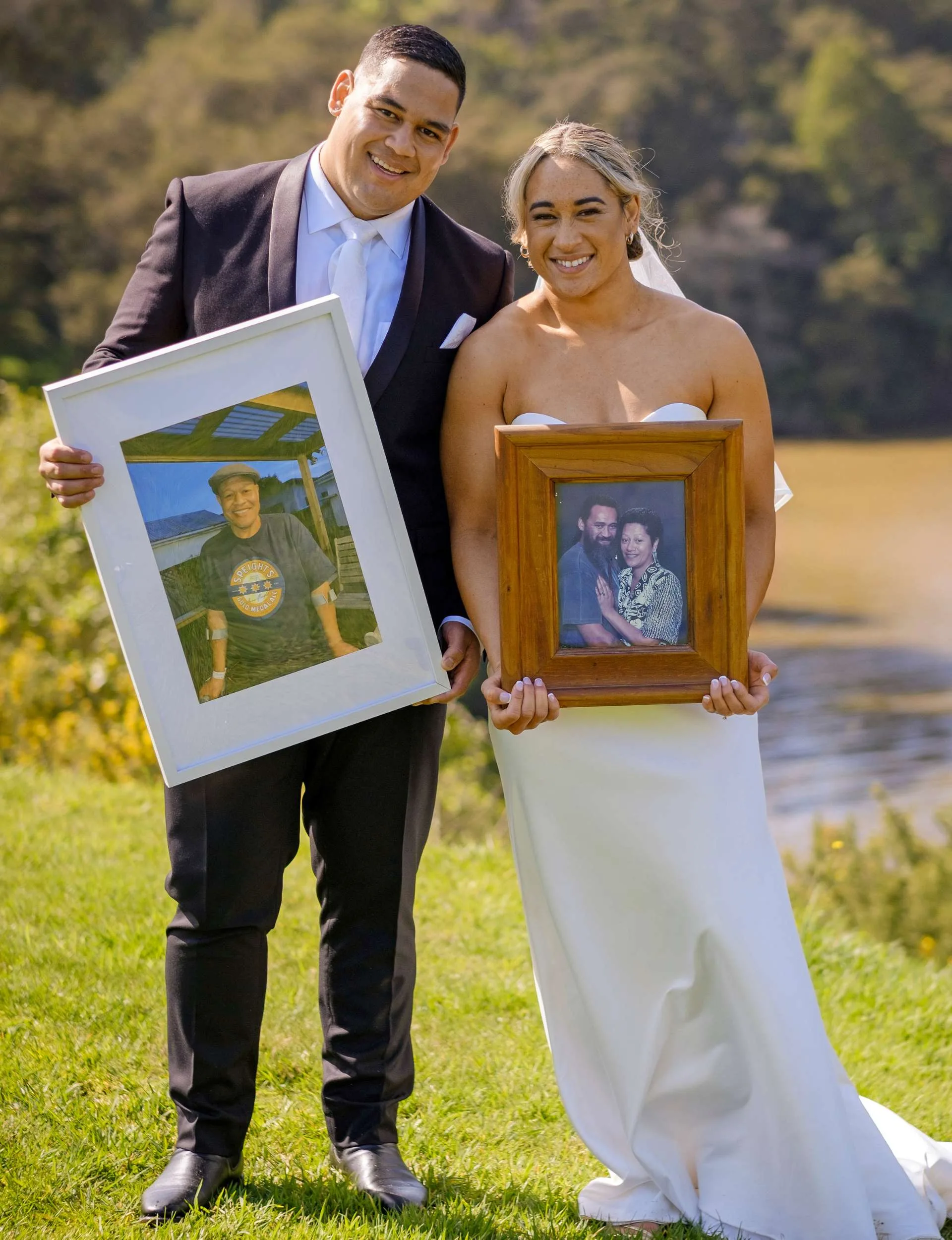 Kennedy and Solly holding up the frames with loved ones pictured inside