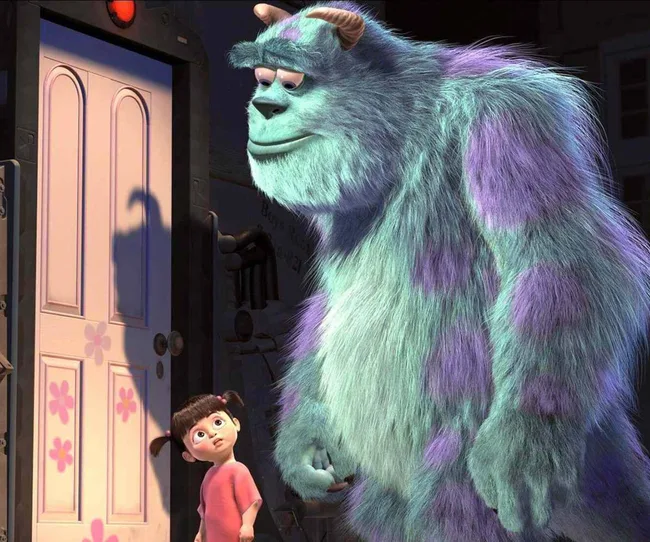 Human child Boo and monster James P. Sullivan stand next to a door