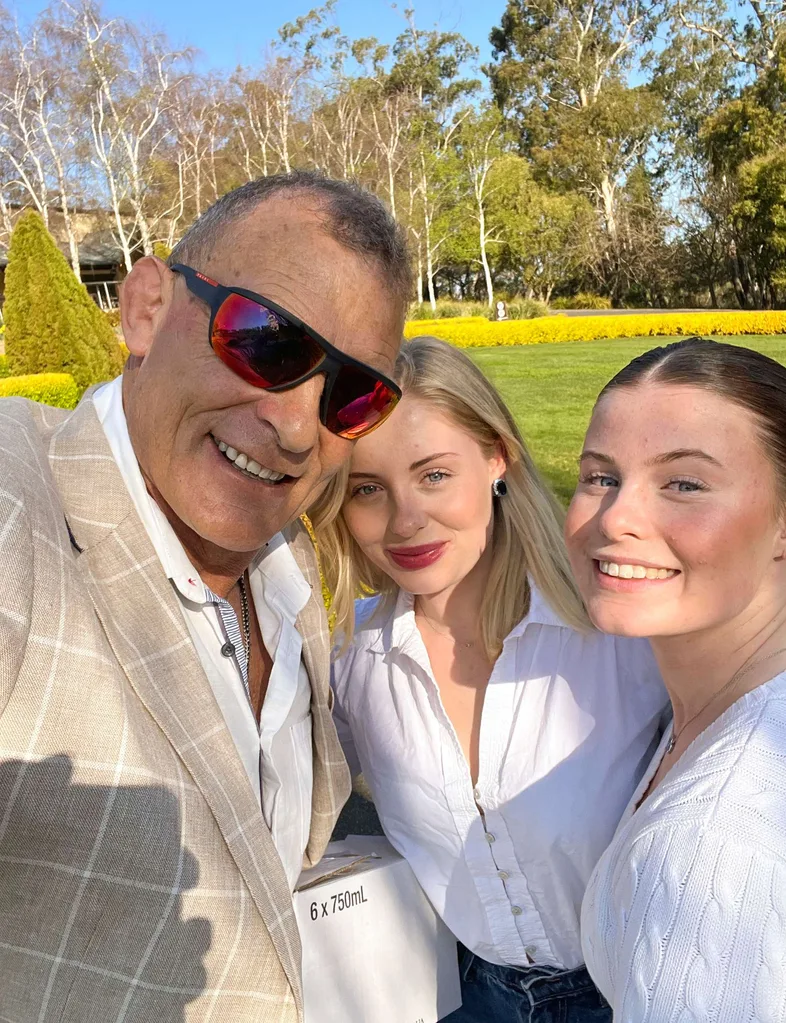 Jud Arthur with his two daughters in a park