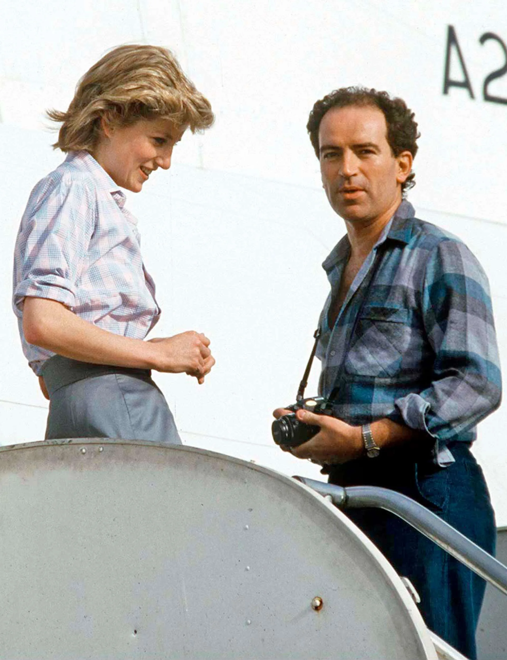 Richard with Princess Diana chatting on the stairs to enter a private jet