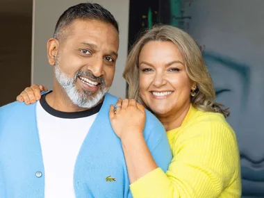 Ganesh Raj with his wife Jo hanging over his shoulder