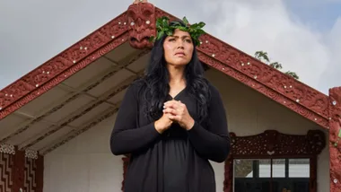 Kristyl in front of the marae with a foliage crown