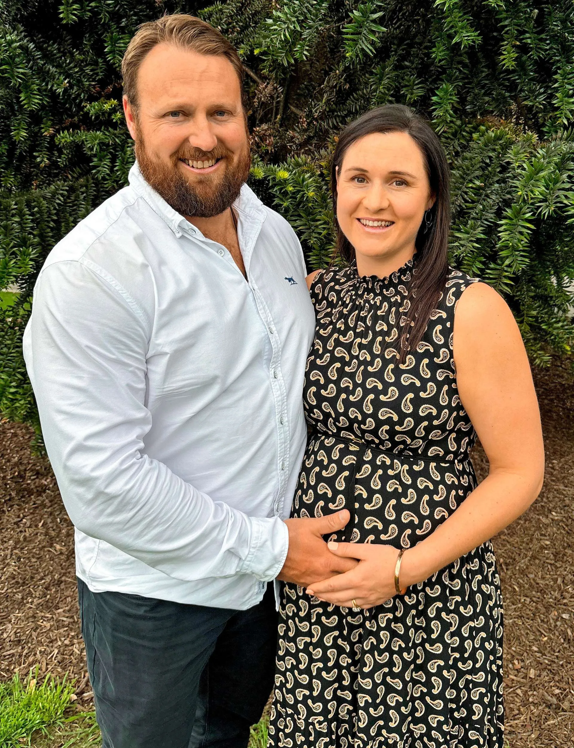 Tom Walsh holding his hand on Dana's pregnant belly