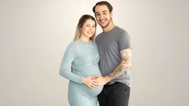 Corrin and Drew cradling her pregnant belly