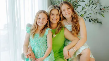 Toni Street with her Matilda star daughters sitting on her lap
