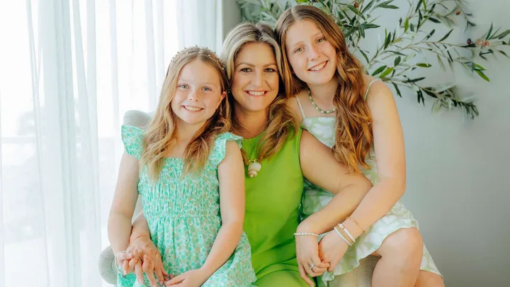 Toni Street with her Matilda star daughters sitting on her lap