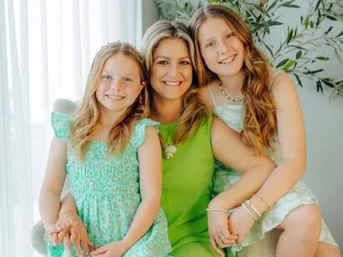 Toni Street with her Matilda star daughters sitting on her lap