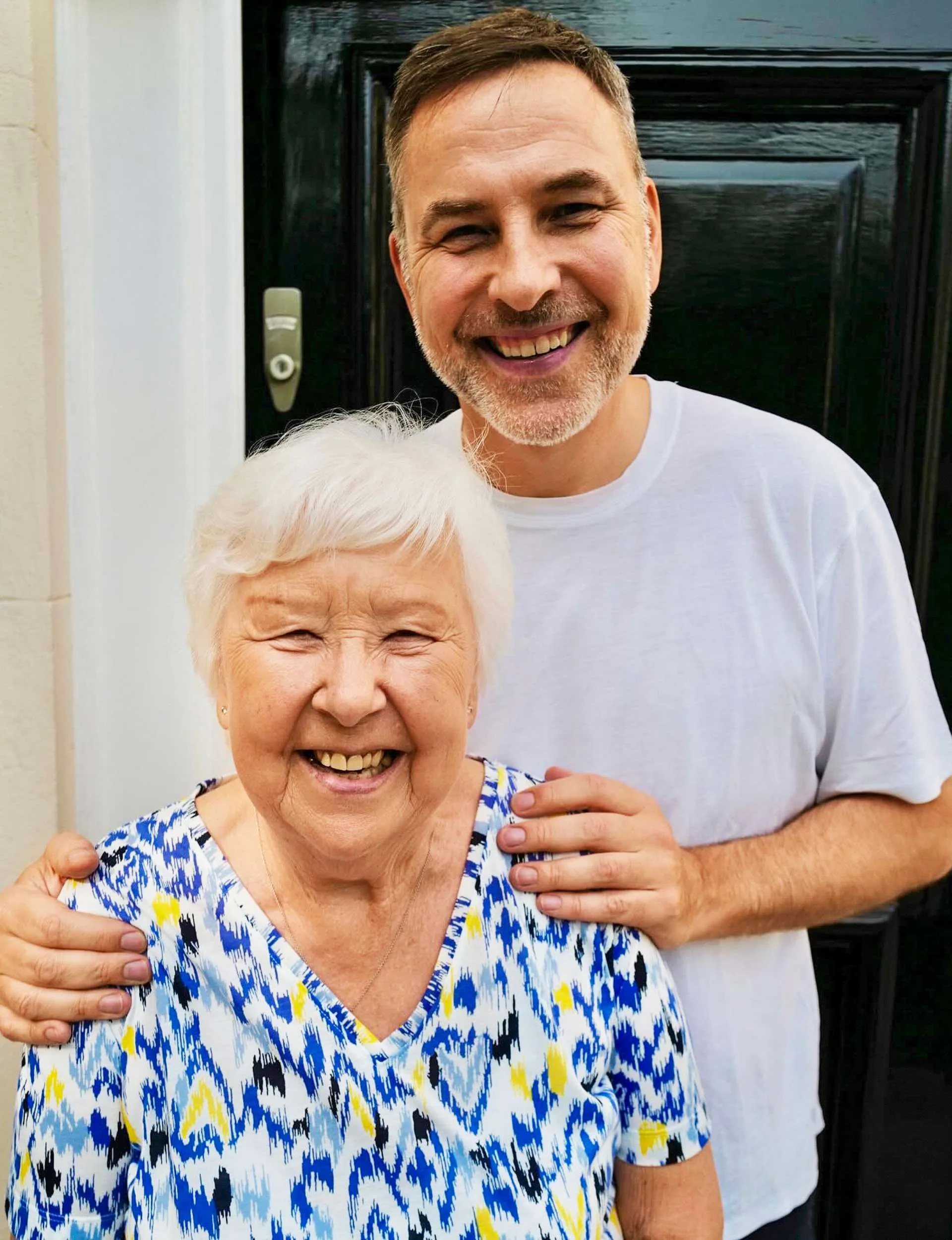 David Walliams with his hands on his Mum Kathleen's shoulders