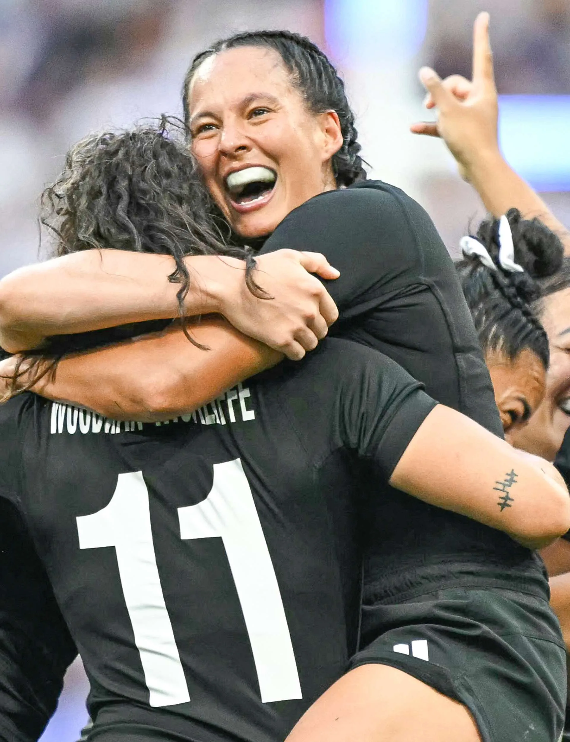 Tyla King jumping on a teammate after the Black Ferns' Olympic win