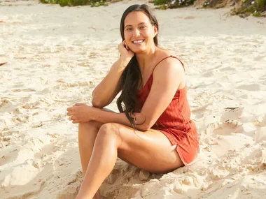 Tyla King siting on a beach