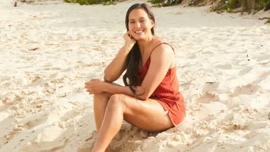 Tyla King siting on a beach