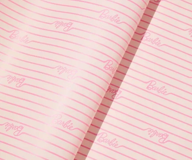 Pink striped Christmas wrapping paper with the Barbie logo all over it