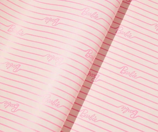 Pink striped Christmas wrapping paper with the Barbie logo all over it