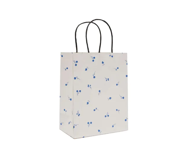 A white gift bag with small blue flowers scattered around