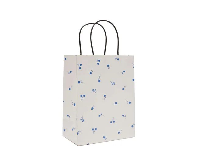 A white gift bag with small blue flowers scattered around