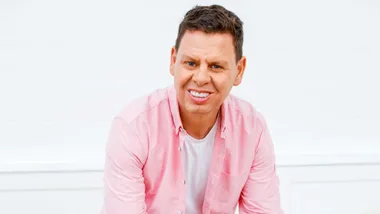 Paddy Gower in a pink button up shirt