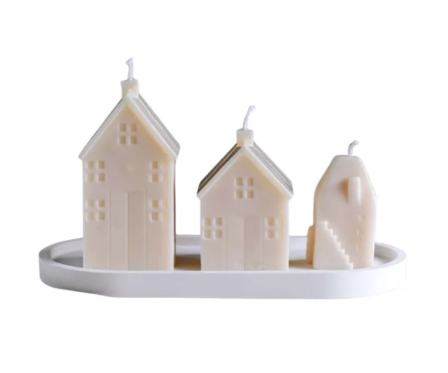 Three different sized house candles are great Secret Santa gifts