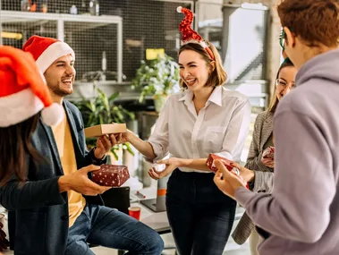 Friends exchanging their best secret santa gifts