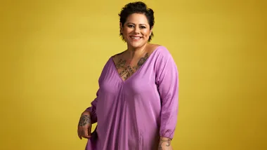 Anika Moa in front of a mustard backdrop