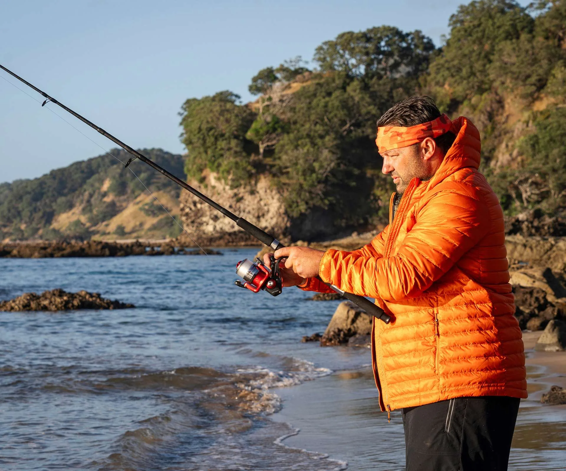 Fishing on the beach for his team