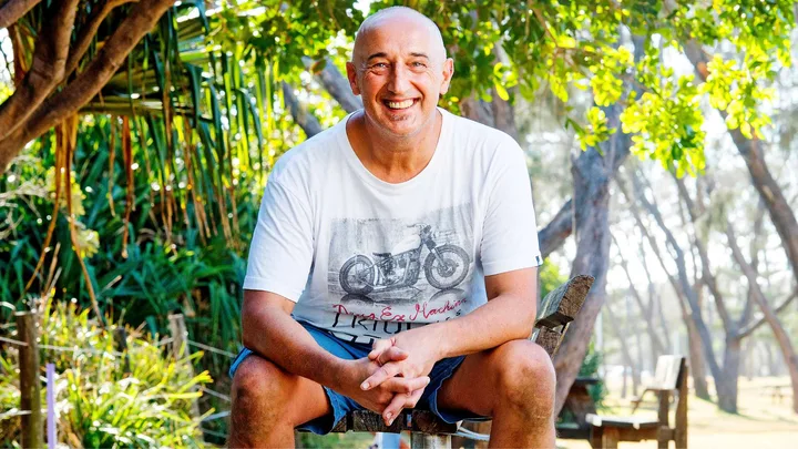 Walter Mikac smiling in a white tee-shirt