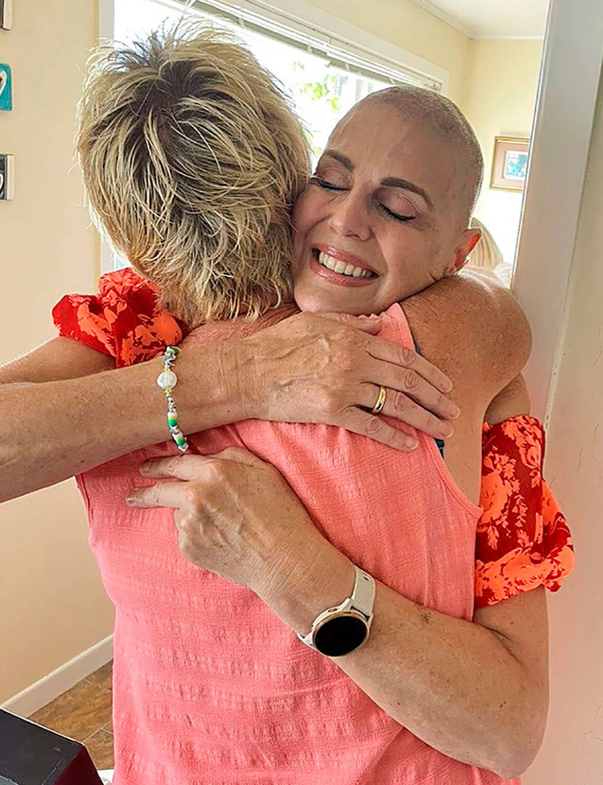 Caro hugging her sister after shaving her head