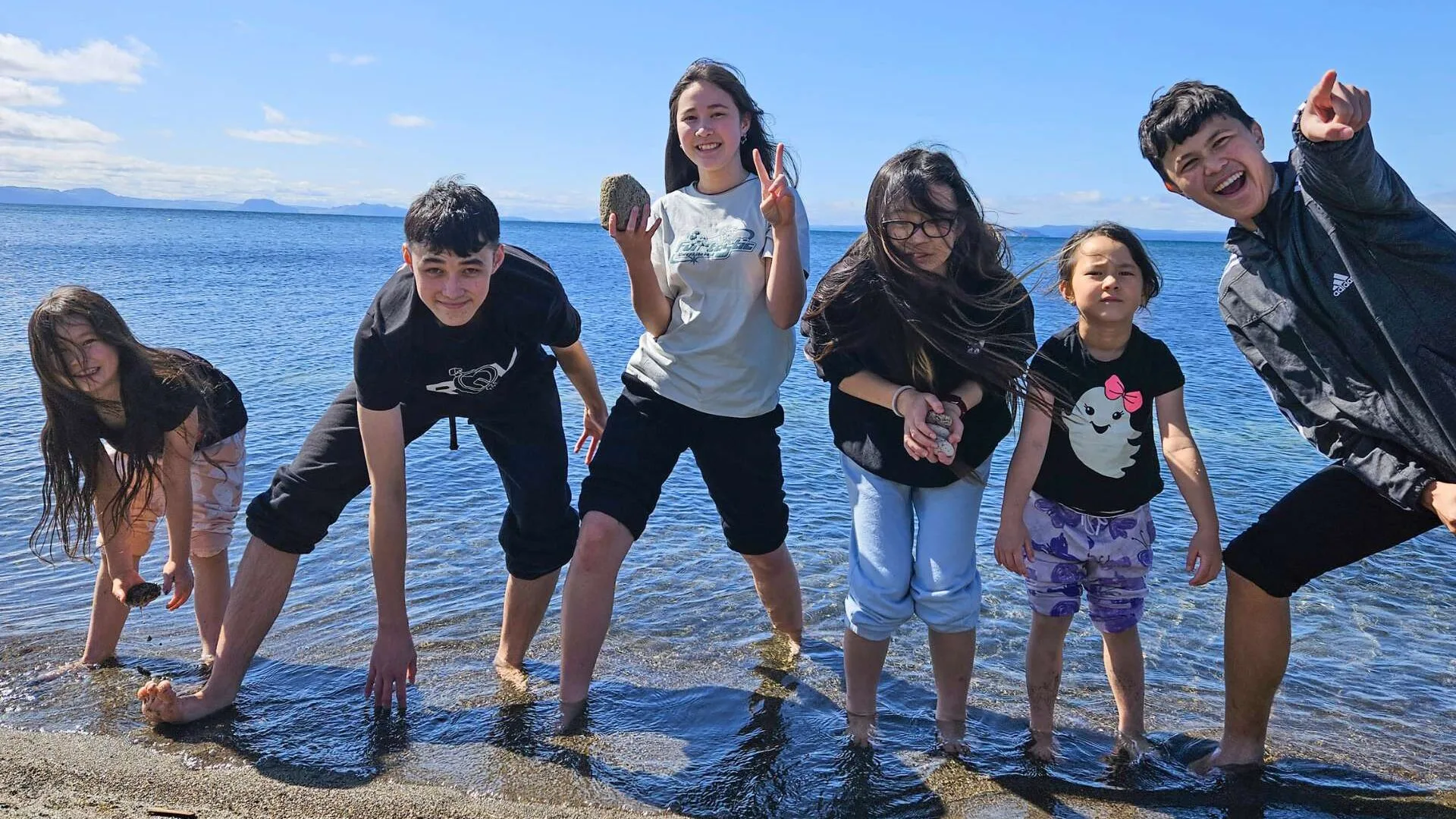 The Milua family kids playing at the beach
