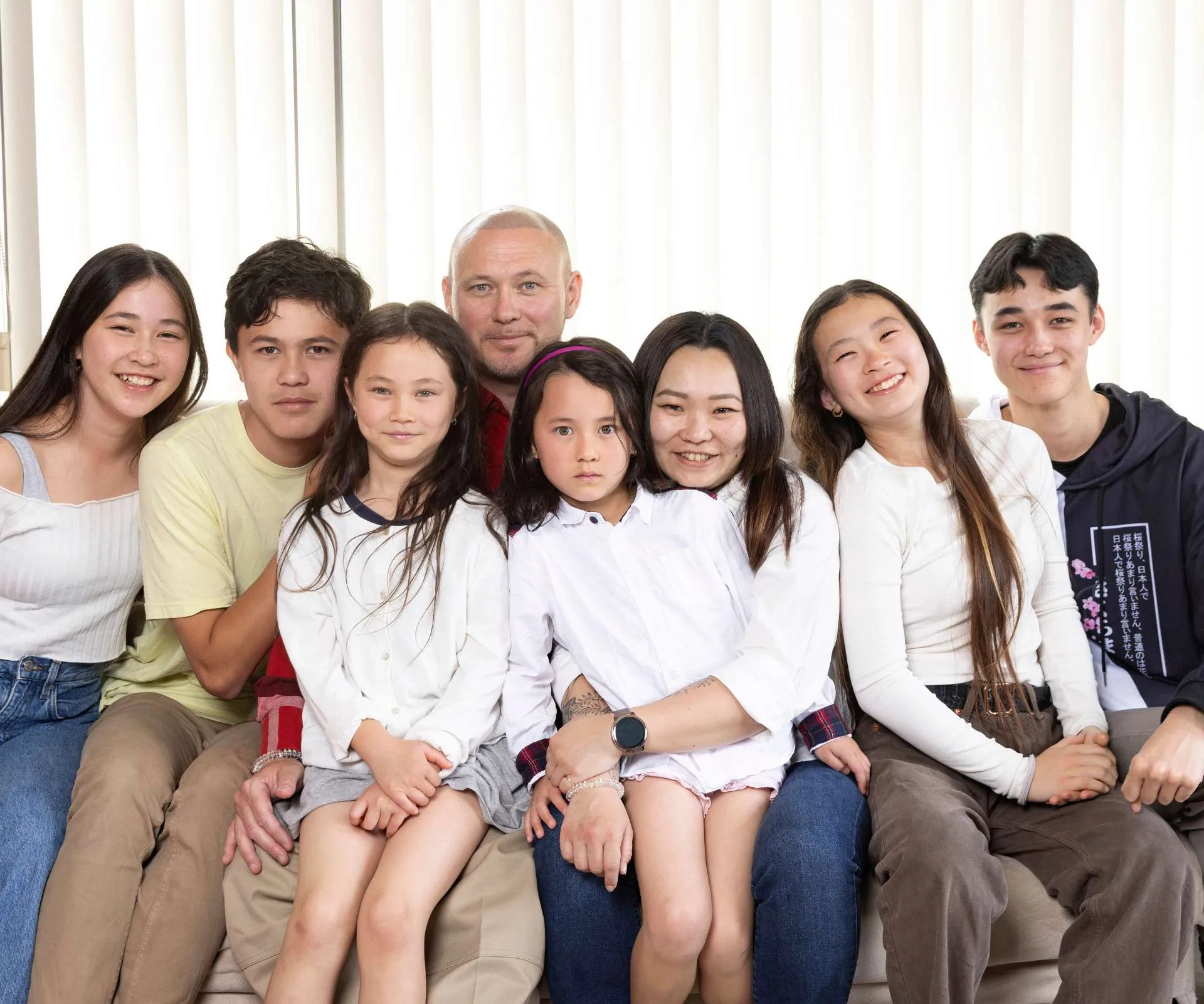 The Milua family piled onto a couch