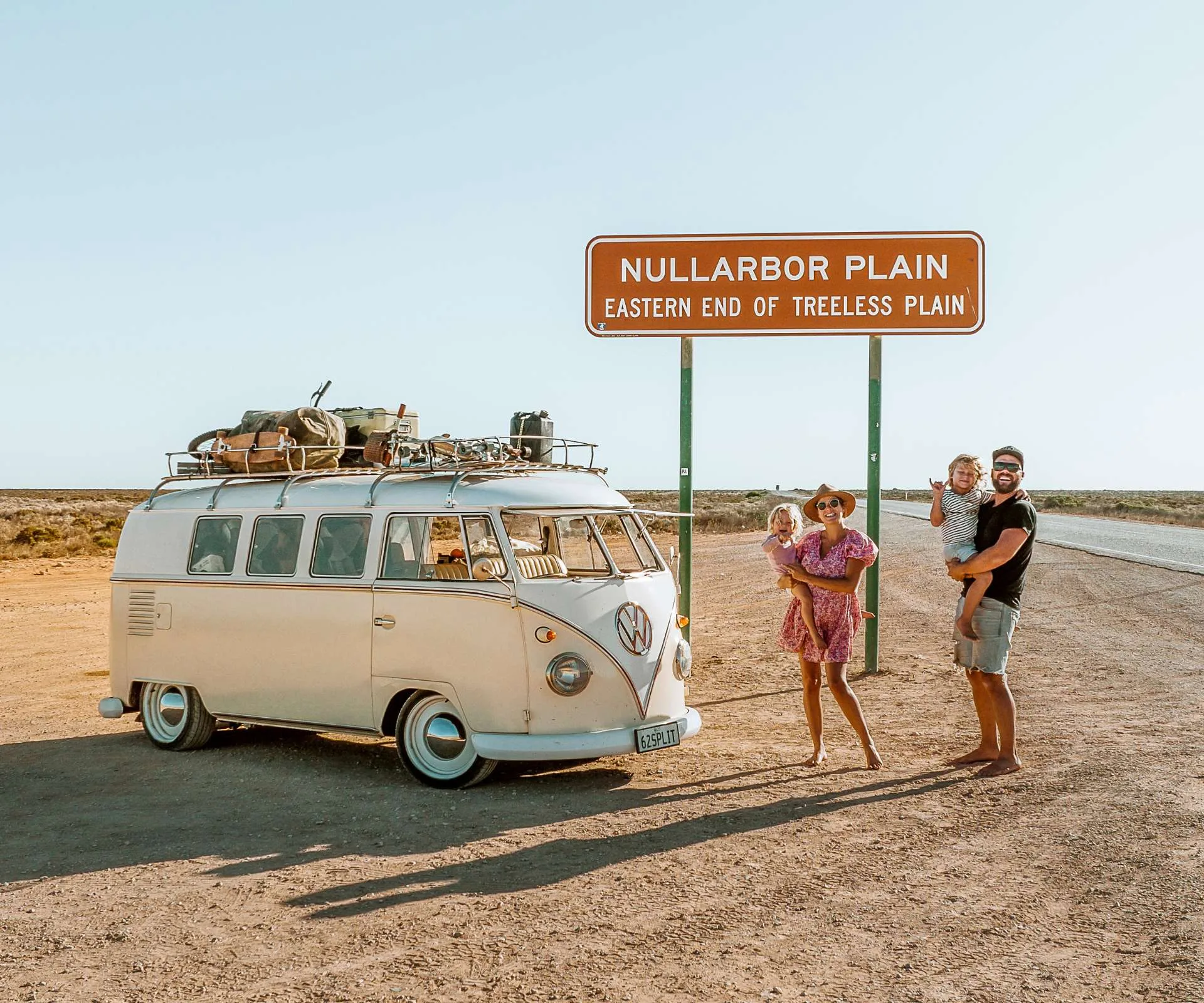 Travel family posing for a photo on the road