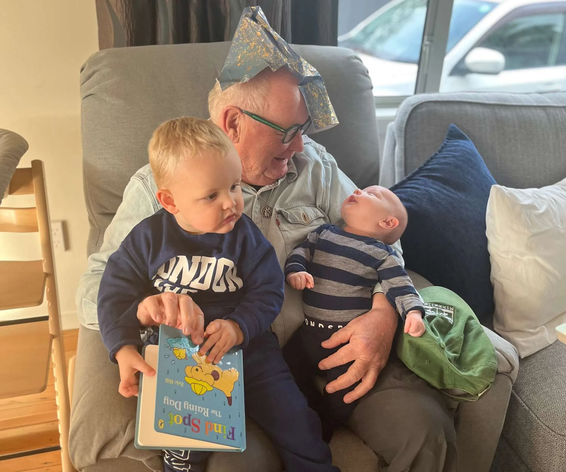 Granddad Kevin Milne reading a book to the grandsons