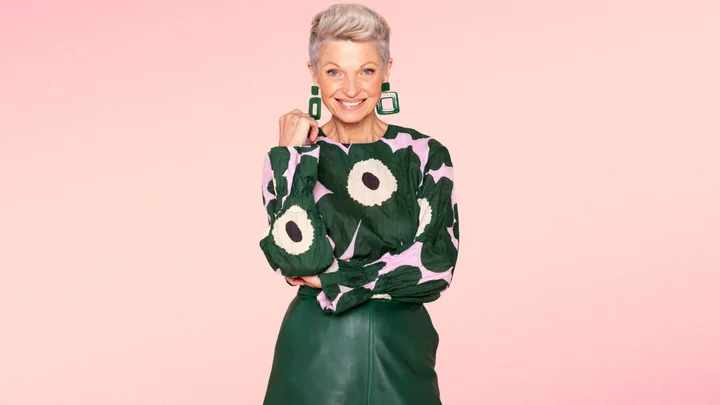 Mature lady in green floral top and green leather skirt
