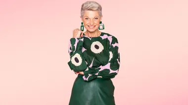 Mature lady in green floral top and green leather skirt