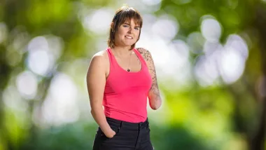 Nikita smiling in a pink top