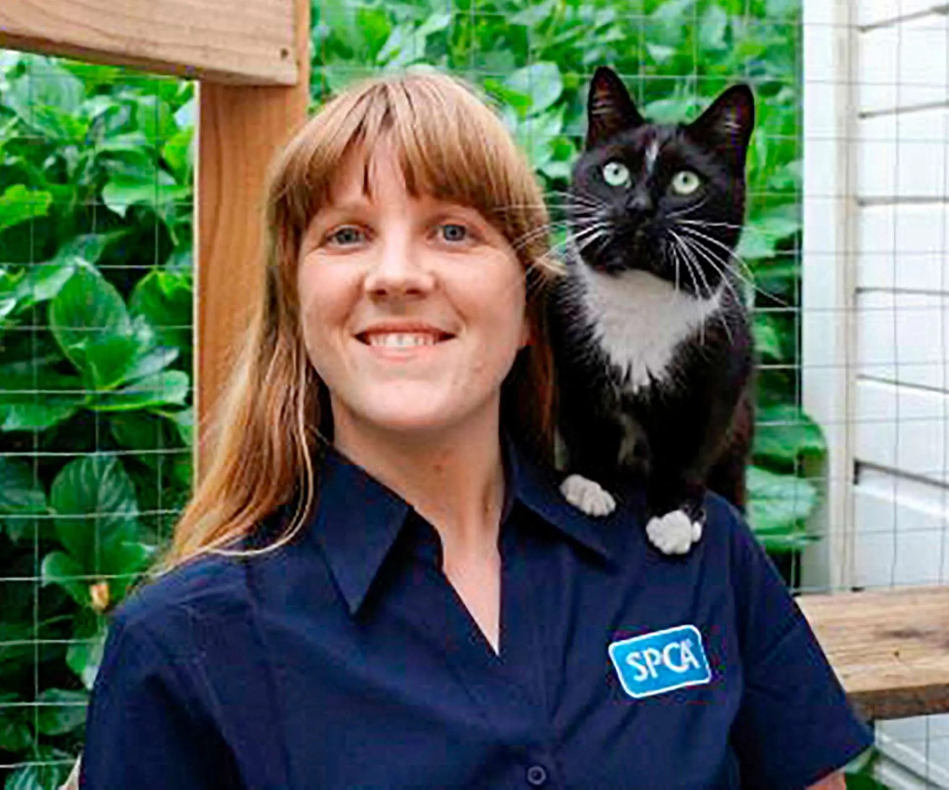 Alison Vaughan with a black and white cat on her shoulder