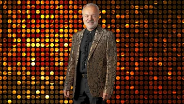 Graham Norton in front of a sequin wall